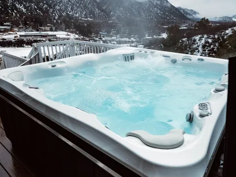 Spa Caldera Utopia Cantabria ouvert sur une terrasse, montagnes enneigées au fond